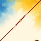 ALVENZA Red Bead Rakhi – Golden Centerpiece & Pearl Details