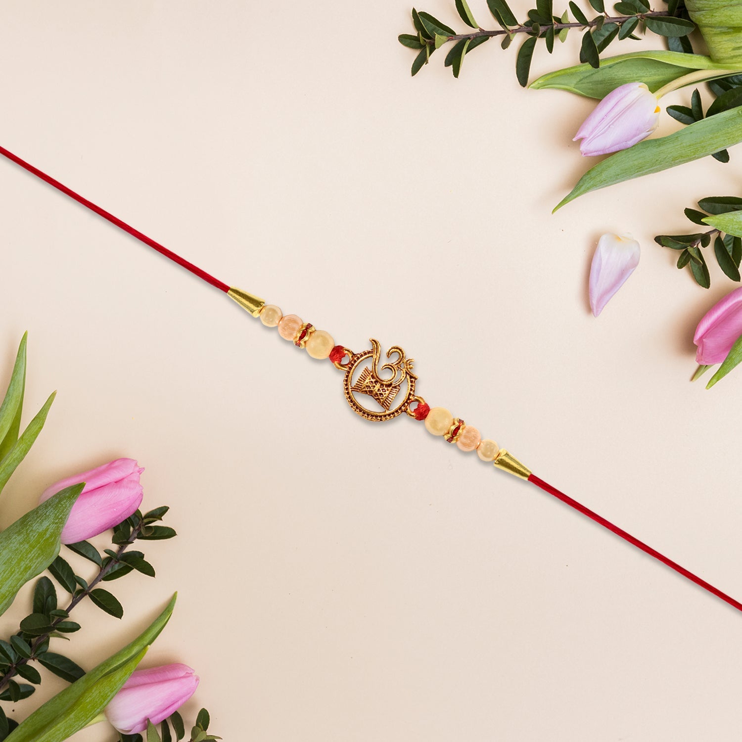 ALVENZA Om Swastik Rakhi - Golden Motif with Pearl Beads for Brother