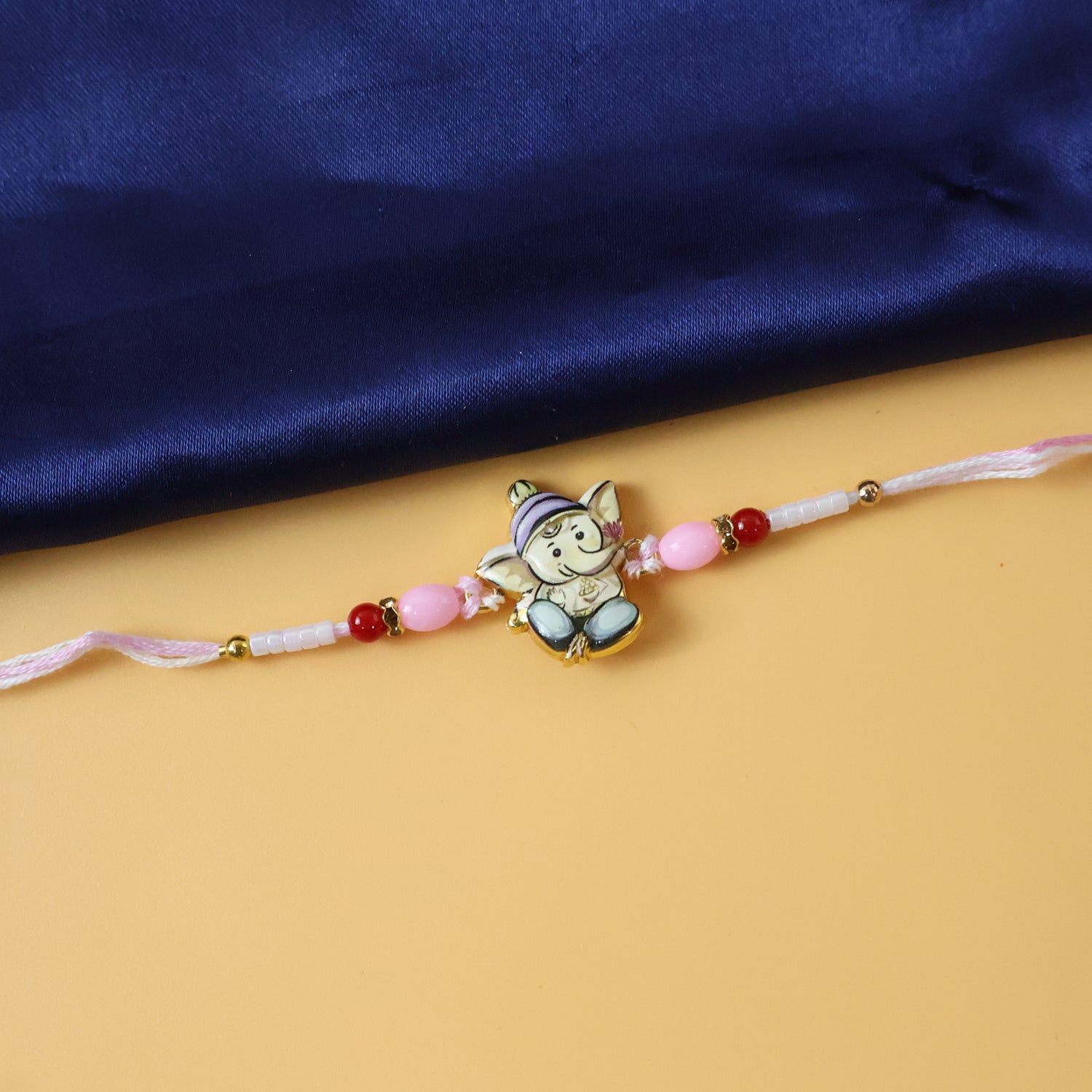 ALVENZA Ganesha Rakhi – Beautiful Pink and Red Beads for Raksha Bandhan