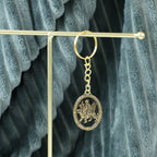 ALVENZA Maa Durga Golden Oval Frame Keychain – Spiritual Protection