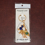 ALVENZA Krishna Peacock Keychain – Spiritual Golden Metal Charm