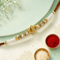 ALVENZA Minimal Pearl Golden Bracelet Rakhi with Sleek Beads and Elegant Red Thread