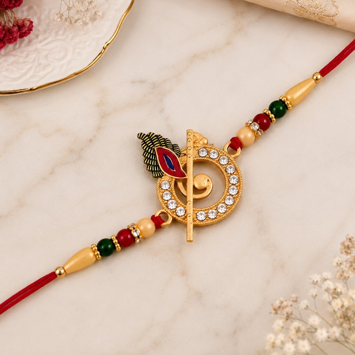 ALVENZA Krishna Flute Rakhi – Stone Studded Peacock Feather Design