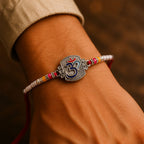 ALVENZA Om Symbol Silver Centre Rakhi with White Beads, Roli Chawal Coin and Peacock Gift Packing