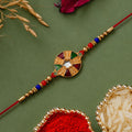 ALVENZA Multicolor Kundan Rakhi - Golden Floral Design with Beaded Red Thread