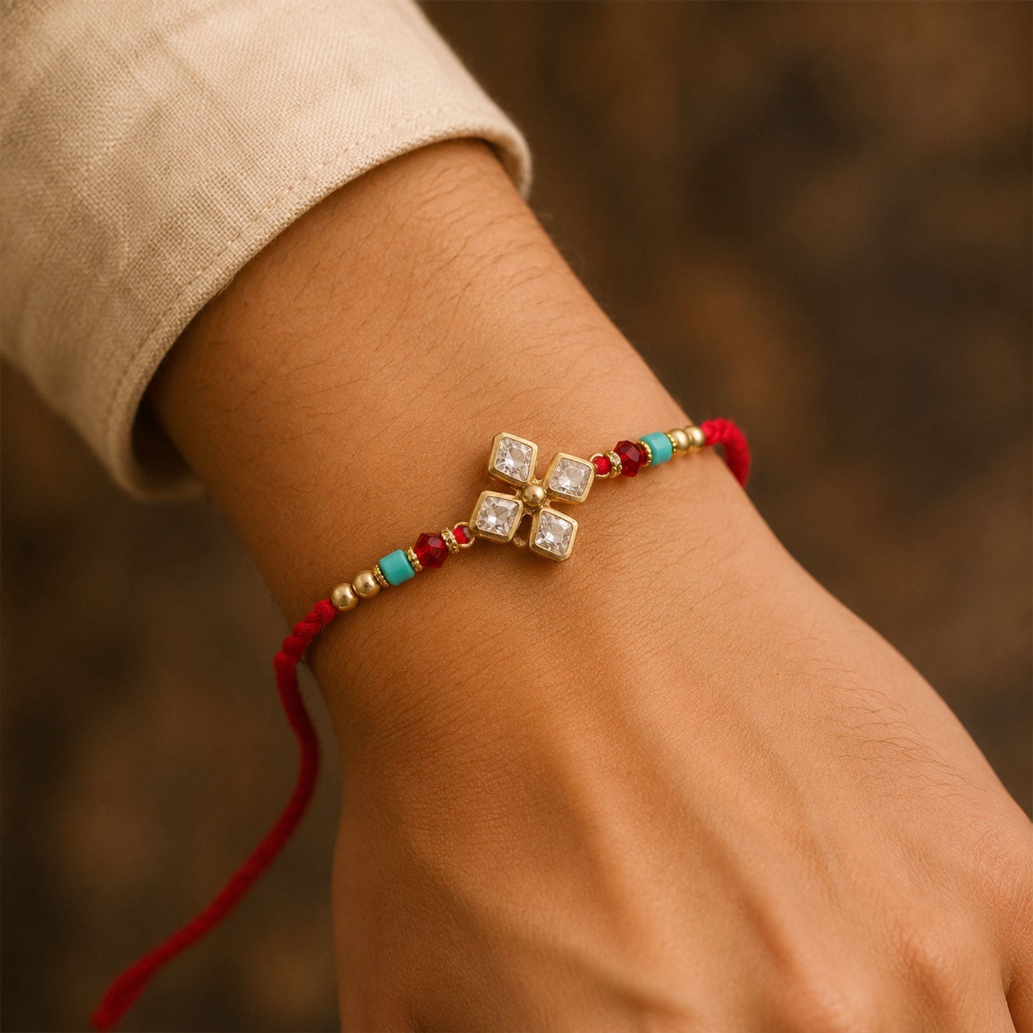 ALVENZA Diamond Crystal Flower Rakhi with Gold Bezels, Turquoise, Red & Golden Beads
