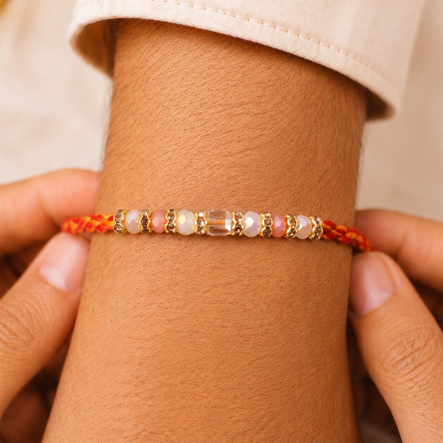 ALVENZA Silver Tone Designer Rakhi with Pastel Beads and Elegant Bracelet Style Finish