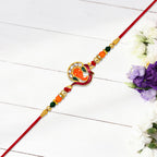 ALVENZA Golden Ganesha Rakhi – Red & Green Beads with Stone Detailing
