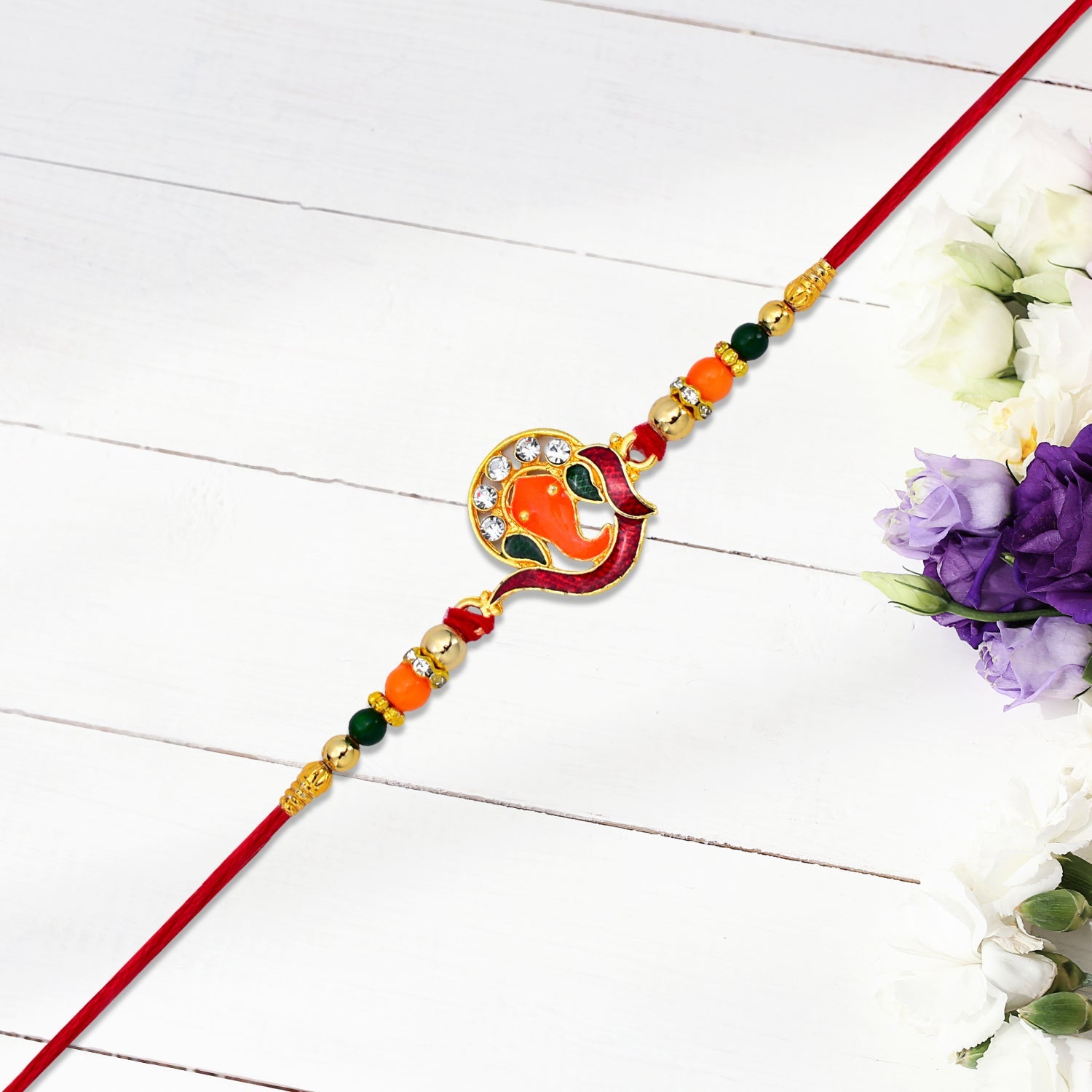 ALVENZA Golden Ganesha Rakhi – Red-Green Beads & Stone Detailing for Brother