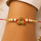 ALVENZA Golden Charm Rakhi - Pearl Beads, Red Thread for Brother