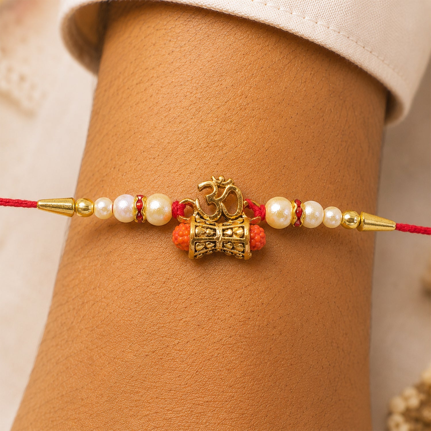 ALVENZA Golden Charm Rakhi - Pearl Beads, Red Thread for Brother