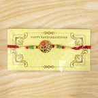 ALVENZA Flower Design Rakhi with Red and Green Beads - Festive Elegance
