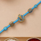 ALVENZA Turquoise Center Designer Rakhi with Gold Tone Detail and Elegant Bracelet Beauty