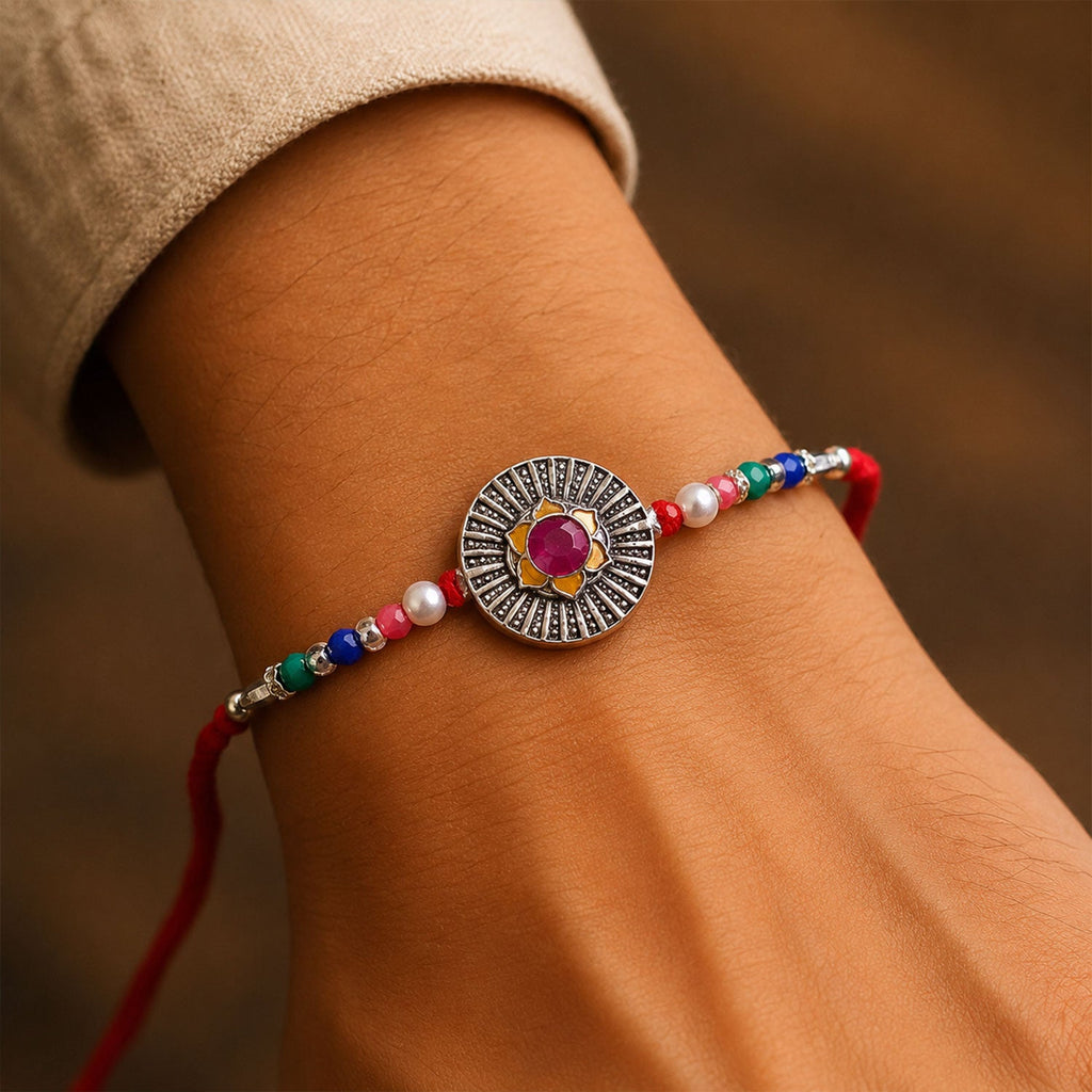 ALVENZA Sunburst Stone Rakhi with Magenta Centre, Pearl Beads, Roli Chawal Coin and Card Packing