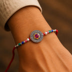 ALVENZA Sunburst Stone Rakhi with Magenta Centre, Pearl Beads, Roli Chawal Coin and Card Packing