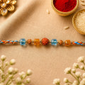 ALVENZA Blue Beaded Bracelet Rakhi with Golden Spacers and Colorful Festive Charm