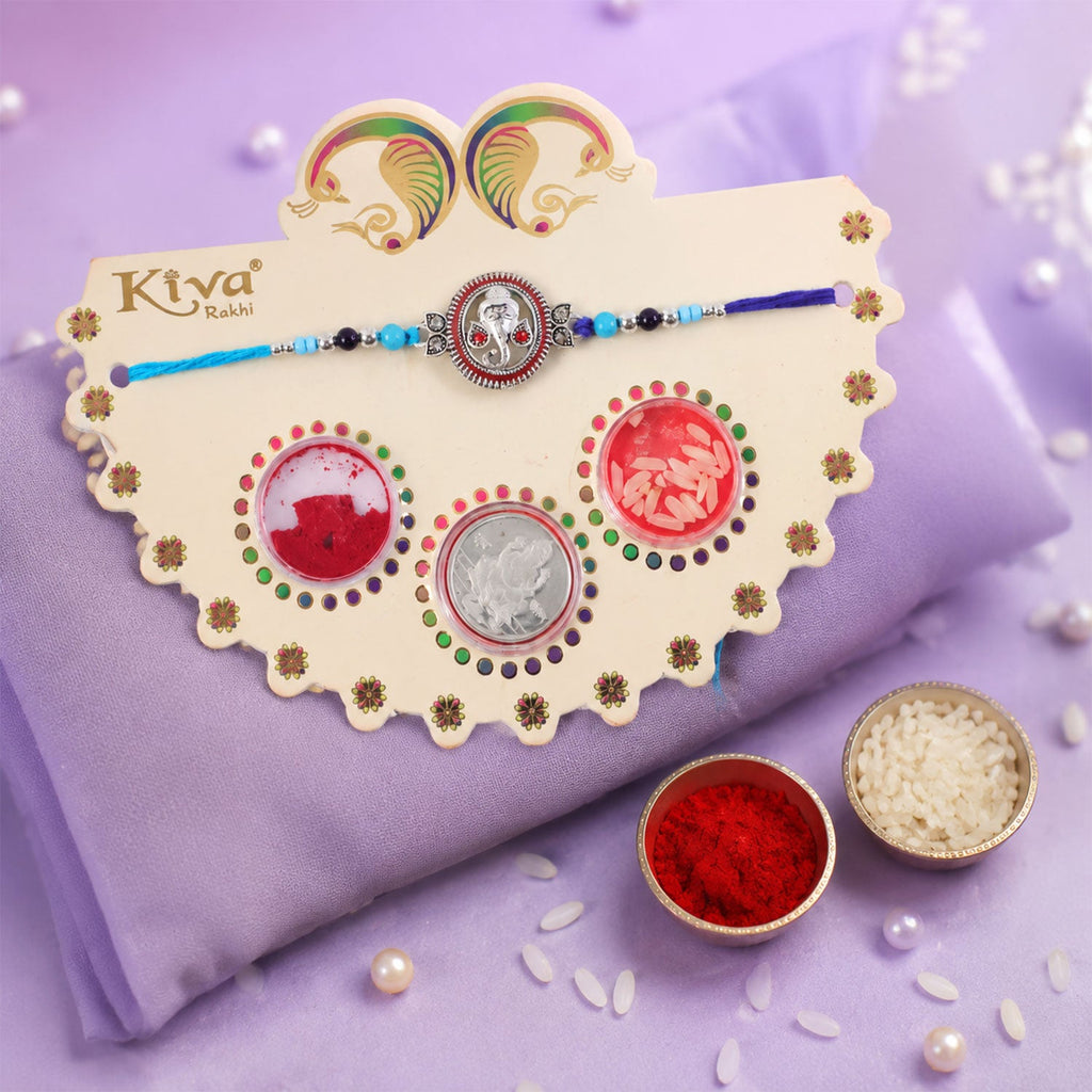 ALVENZA Round Ganesha Medallion Rakhi with Blue Thread, Roli Chawal Coin and Peacock Card Packing