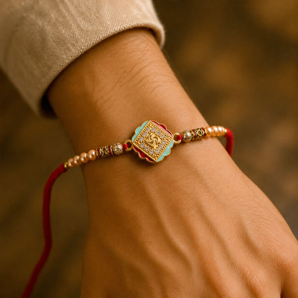 ALVENZA Golden Swastik AD Stone Rakhi with Turquoise-Red Meenakari and Pearl Beads