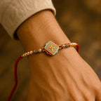 ALVENZA Golden Swastik AD Stone Rakhi with Turquoise-Red Meenakari and Pearl Beads