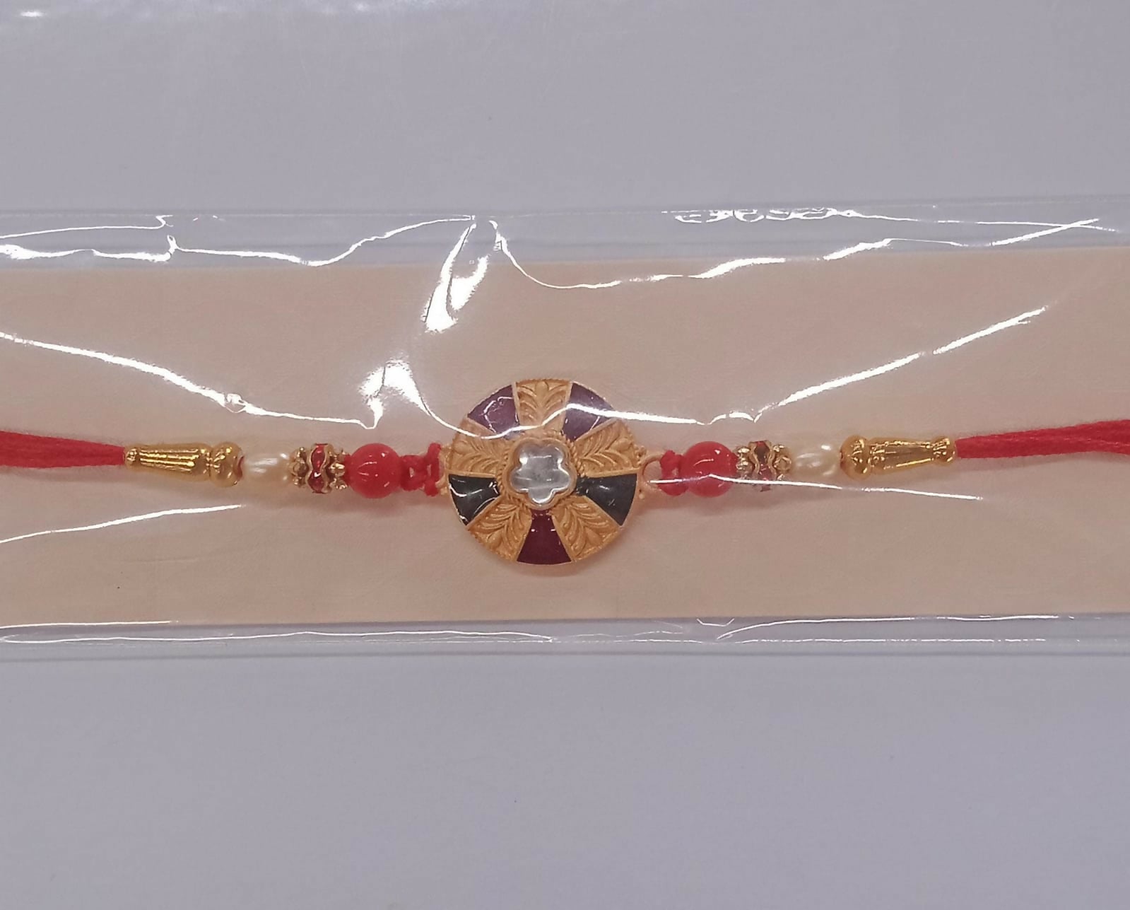 ALVENZA Multicolor Kundan Rakhi - Golden Floral Design with Beaded Red Thread