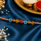 ALVENZA Blue Beaded Bracelet Rakhi with Golden Spacers and Colorful Festive Charm