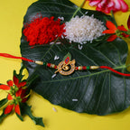 ALVENZA Krishna Flute Rakhi – Stone Studded Peacock Feather Design