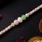 ALVENZA Pastel Pearl Bracelet Rakhi with Soft Pink Green Beads and Delicate Designer Beauty