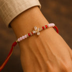 ALVENZA Crystal Pinwheel Rakhi with Baguette AD Stones, Soft Pink & Red Crystal Beads