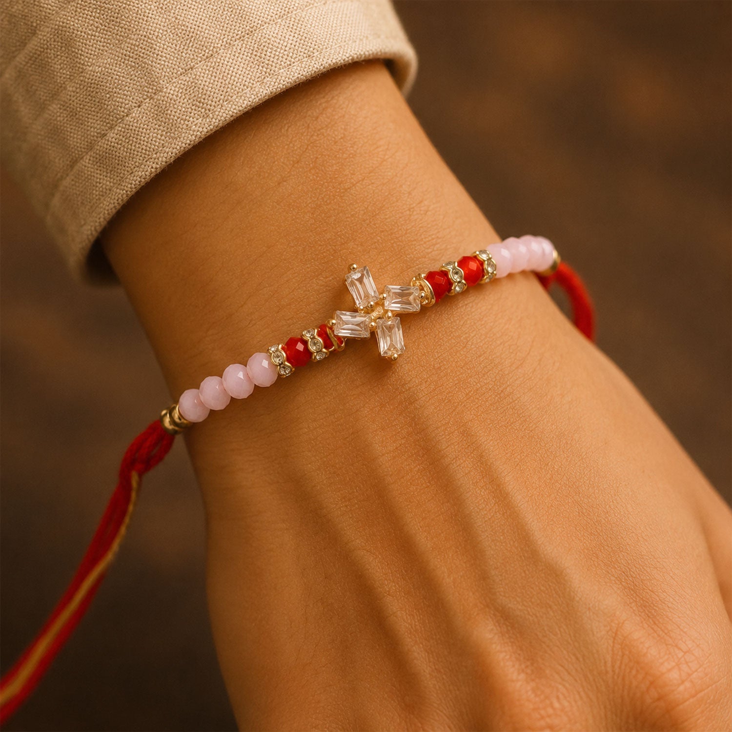 ALVENZA Crystal Pinwheel Rakhi with Baguette AD Stones, Soft Pink & Red Crystal Beads