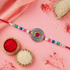 ALVENZA Sunburst Stone Rakhi with Magenta Centre, Pearl Beads, Roli Chawal Coin and Card Packing