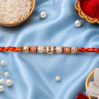 ALVENZA Silver Tone Designer Rakhi with Pastel Beads and Elegant Bracelet Style Finish