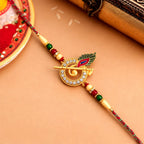 ALVENZA Krishna Flute Rakhi – Stone Studded Peacock Feather Design