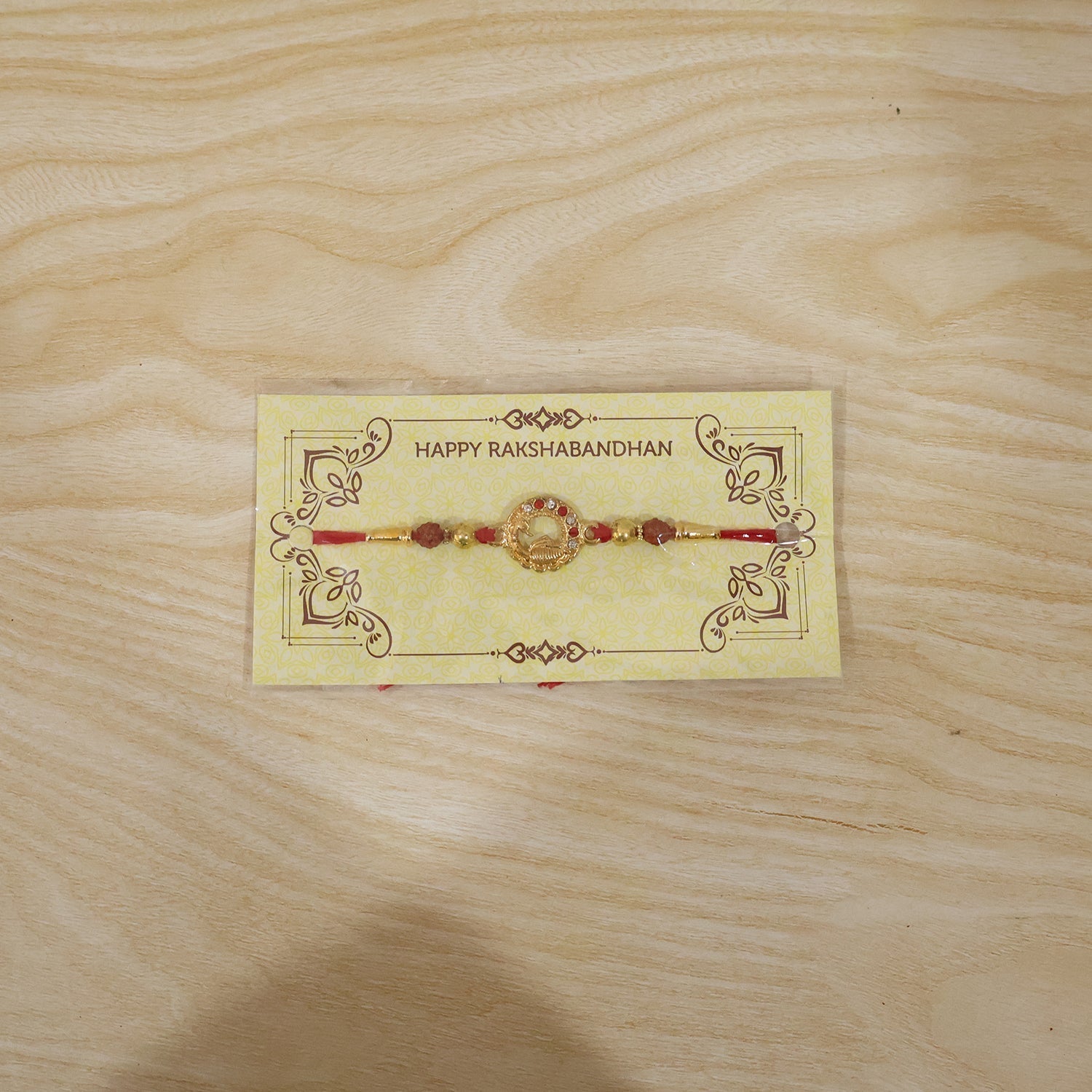 ALVENZA Golden Peacock Rakhi – Elegant Design with Rudraksha Beads for Brothers