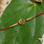 ALVENZA Rakhi – Elegant pearl bead design with red thread for siblings