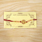 ALVENZA Rakhi – Elegant pearl bead design with red thread for siblings
