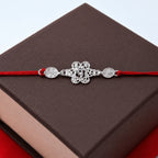 ALVENZA Silver Floral Om Rakhi – Elegant Red Thread for Rakshabandhan