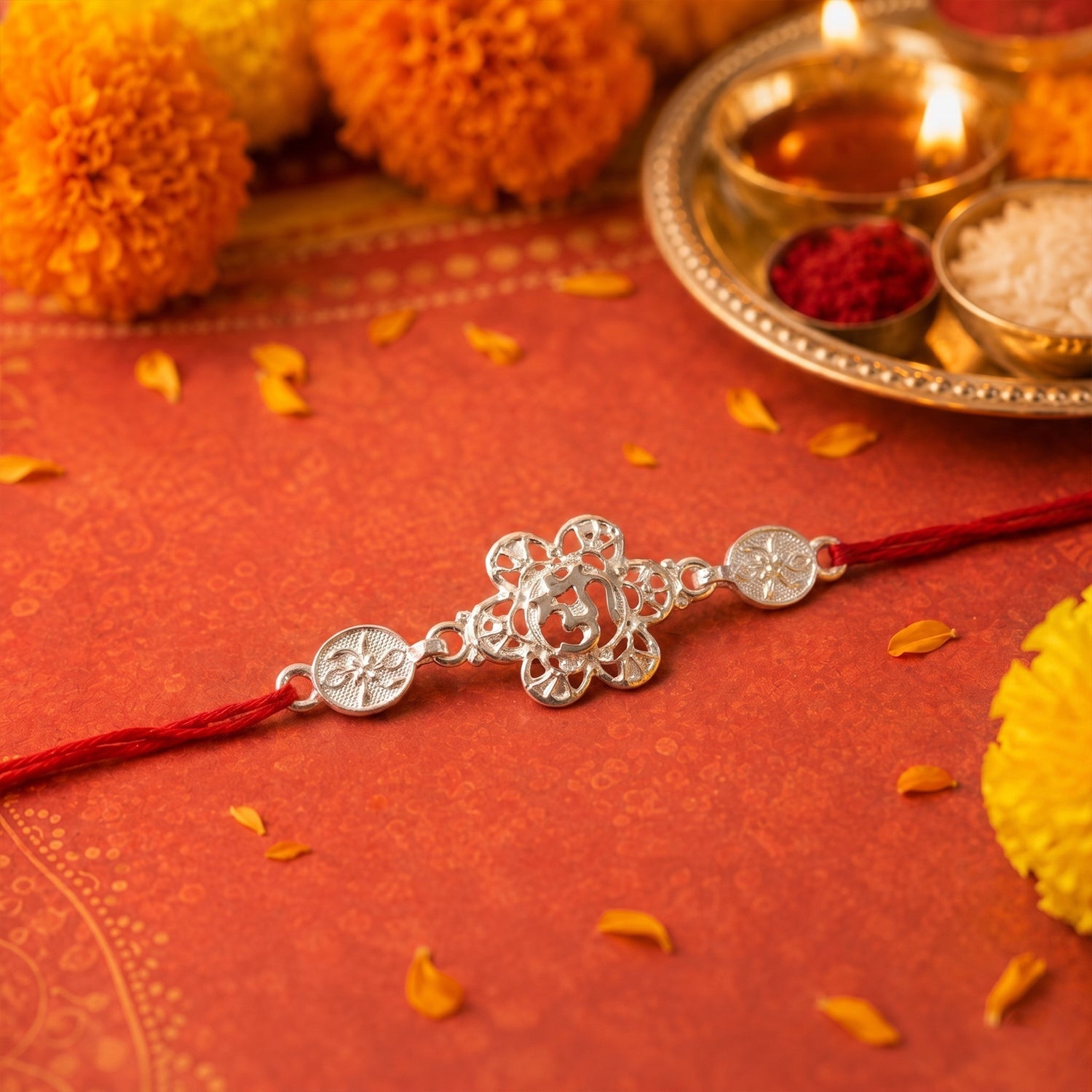 ALVENZA Silver Floral Om Rakhi – Elegant Red Thread for Rakshabandhan